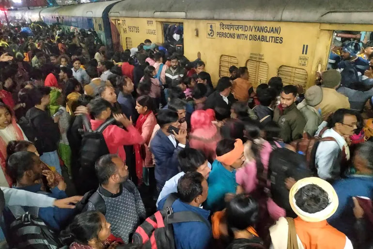 At least 15 people die in a crowd crash at a train station in India