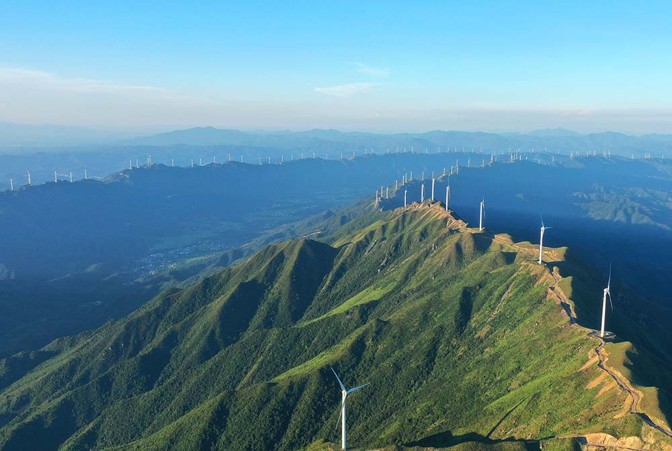 Wind power turbines line a mountain range in Ji’an, Jiangxi province, July 9, 2022.
